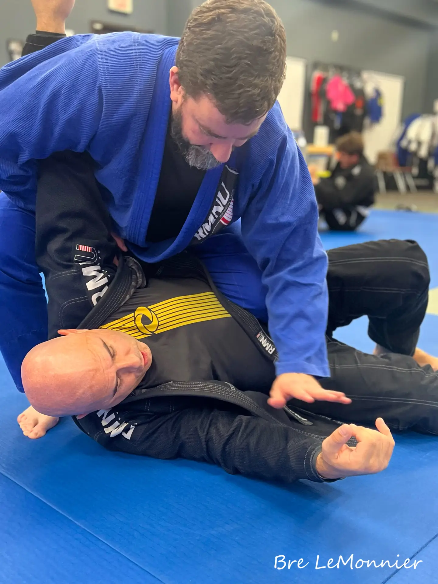 Adults practicing Brazilian Jiu Jitsu at Frequency Martial Arts in Bloomington, IL, improving fitness, self-defense, and confidence.